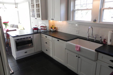 Example of a small transitional kitchen design in Cincinnati with a drop-in sink and white cabinets