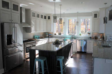 Inspiration for a medium sized traditional u-shaped open plan kitchen in Nashville with a belfast sink, shaker cabinets, white cabinets, granite worktops, stainless steel appliances, dark hardwood flooring and an island.
