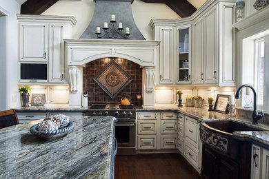 Eat-in kitchen - large transitional l-shaped dark wood floor and brown floor eat-in kitchen idea in Birmingham with a farmhouse sink, raised-panel cabinets, white cabinets, brown backsplash, stainless steel appliances and an island