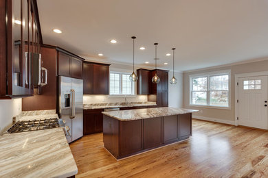 Example of a large classic medium tone wood floor eat-in kitchen design in DC Metro with an undermount sink, shaker cabinets, dark wood cabinets, quartzite countertops, stainless steel appliances and an island