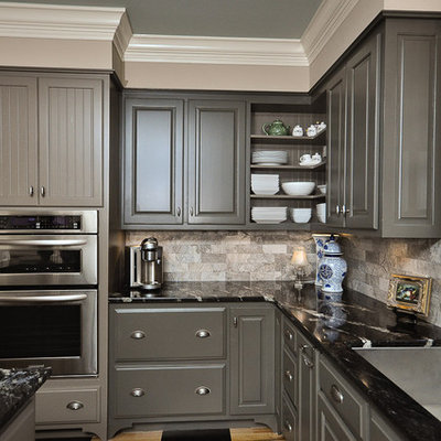 Inspiration for a mid-sized timeless l-shaped painted wood floor kitchen remodel in Other with raised-panel cabinets, gray cabinets, gray backsplash, stainless steel appliances, granite countertops, an island, marble backsplash and an undermount sink