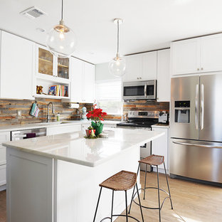 Inspiration for a small transitional open plan kitchen in Orlando with an undermount sink, shaker cabinets, white cabinets, marble benchtops, stainless steel appliances, light hardwood floors, with island, brown splashback and slate splashback.