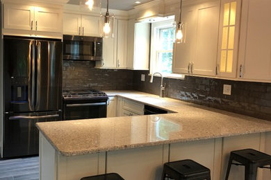 Large trendy u-shaped ceramic tile and gray floor eat-in kitchen photo in New York with an undermount sink, shaker cabinets, white cabinets, quartzite countertops, gray backsplash, ceramic backsplash, stainless steel appliances and gray countertops
