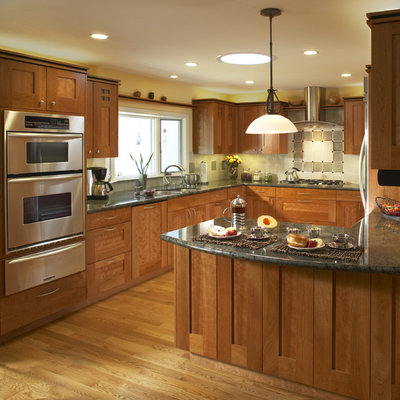 Elegant u-shaped kitchen photo in San Francisco with stainless steel appliances, a double-bowl sink, shaker cabinets, medium tone wood cabinets and granite countertops