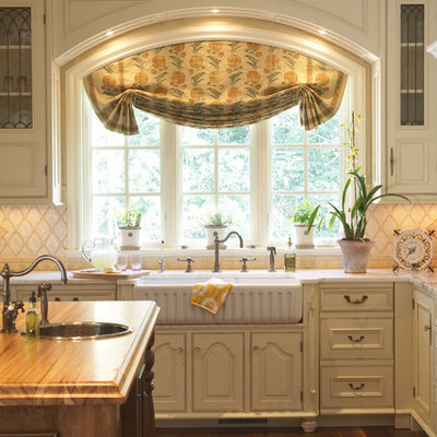 Inspiration for a timeless kitchen remodel in Minneapolis with a farmhouse sink and wood countertops