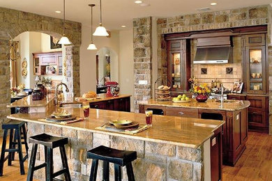 Example of a large minimalist single-wall medium tone wood floor kitchen design in Dallas with an undermount sink, granite countertops, beige backsplash, ceramic backsplash, stainless steel appliances and two islands