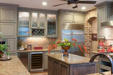 Inspiration for a mid-sized transitional u-shaped ceramic tile eat-in kitchen remodel in Other with a farmhouse sink, raised-panel cabinets, stainless steel cabinets, stainless steel countertops, multicolored backsplash, mosaic tile backsplash, stainless steel appliances and an island