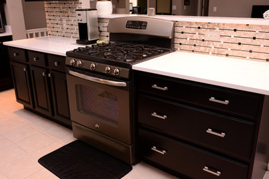 Photo of a traditional kitchen in Detroit with raised-panel cabinets and dark wood cabinets.