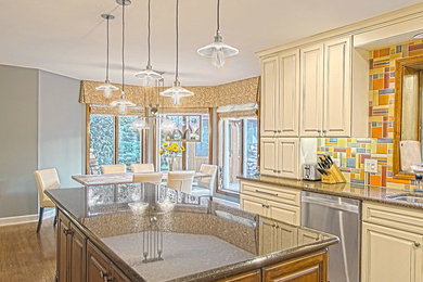 Mid-sized eclectic u-shaped medium tone wood floor and brown floor eat-in kitchen photo in Chicago with an undermount sink, raised-panel cabinets, beige cabinets, granite countertops, multicolored backsplash, ceramic backsplash, stainless steel appliances and an island