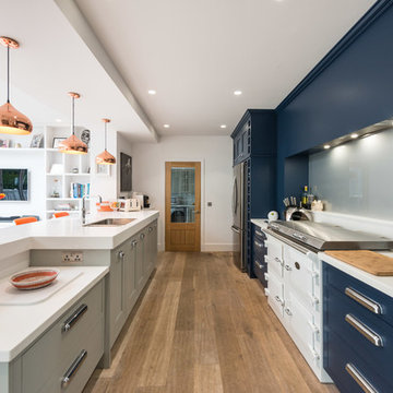 Kitchen in navy, white and grey with orange and copper accents