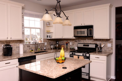 Example of a classic kitchen design in Detroit with recessed-panel cabinets, white cabinets and an island