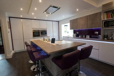 Large modern kitchen in Manchester with stainless steel appliances and a breakfast bar.