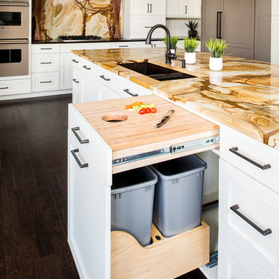 Kitchen - large transitional l-shaped dark wood floor kitchen idea in New York with an undermount sink, shaker cabinets, white cabinets, granite countertops, multicolored backsplash, stone slab backsplash, paneled appliances and an island