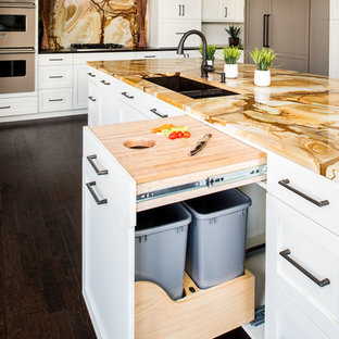 Large transitional eat-in kitchen remodeling - Eat-in kitchen - large transitional l-shaped dark wood floor eat-in kitchen idea in New York with an undermount sink, shaker cabinets, white cabinets, granite countertops, multicolored backsplash, stone slab backsplash, paneled appliances and an island