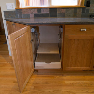 Inspiration for a large arts and crafts l-shaped open plan kitchen in Other with an undermount sink, shaker cabinets, medium wood cabinets, quartz benchtops, multi-coloured splashback, slate splashback, stainless steel appliances, medium hardwood floors, with island and multi-coloured floor.