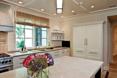 Example of a trendy kitchen design in Indianapolis with an undermount sink, white cabinets, beige backsplash and stainless steel appliances