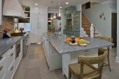 Example of a mid-sized transitional l-shaped limestone floor and gray floor eat-in kitchen design in Houston with an undermount sink, shaker cabinets, white cabinets, stainless steel appliances, an island, quartz countertops, gray backsplash and brick backsplash