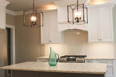 Example of a mid-sized transitional u-shaped eat-in kitchen design in Birmingham with an undermount sink, recessed-panel cabinets, white cabinets, quartz countertops, white backsplash, ceramic backsplash, stainless steel appliances, an island and white countertops