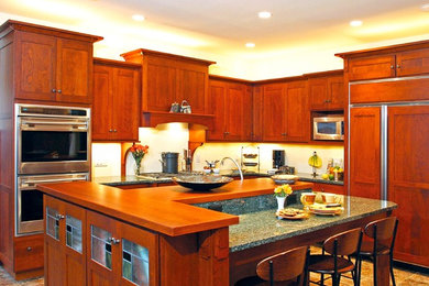 Example of a mid-sized classic kitchen design in Other with shaker cabinets, medium tone wood cabinets, paneled appliances and an island