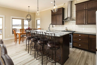 Inspiration for a mid-sized transitional single-wall beige floor open concept kitchen remodel in Grand Rapids with an undermount sink, recessed-panel cabinets, medium tone wood cabinets, granite countertops, beige backsplash, ceramic backsplash, stainless steel appliances and an island