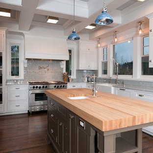 Traditional kitchen inspiration - Example of a classic kitchen design in Portland with shaker cabinets, stainless steel appliances, wood countertops, a farmhouse sink, white cabinets and blue backsplash