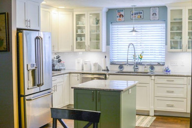 Eat-in kitchen - mid-sized transitional l-shaped light wood floor eat-in kitchen idea in Other with a drop-in sink, glass-front cabinets, white cabinets, white backsplash, stainless steel appliances and an island