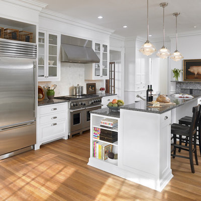 Elegant kitchen photo in Philadelphia with glass-front cabinets and stainless steel appliances