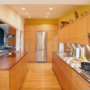 Design ideas for a contemporary kitchen in DC Metro with stainless steel appliances, stainless steel benchtops, an integrated sink, metallic splashback and metal splashback.