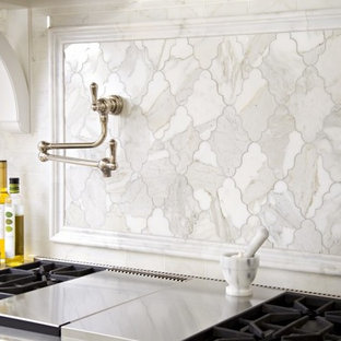 Kitchen ideas - Example of a kitchen design in Charlotte with gray cabinets and gray backsplash