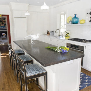 Photo of a contemporary kitchen in Charlotte with limestone benchtops, shaker cabinets, white cabinets, white splashback, subway tile splashback and panelled appliances.