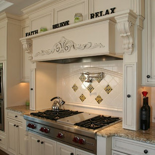 Design ideas for a traditional kitchen in Providence with stainless steel appliances, granite benchtops and multi-coloured splashback.