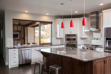 Open concept kitchen - large contemporary u-shaped open concept kitchen idea in Denver with an undermount sink, shaker cabinets, white cabinets, granite countertops, white backsplash, subway tile backsplash, stainless steel appliances and an island