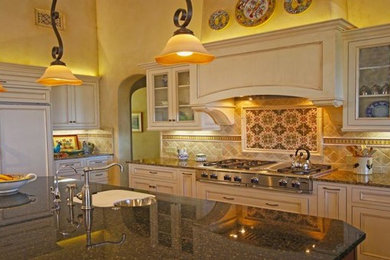Tuscan eat-in kitchen photo in Santa Barbara with an undermount sink, raised-panel cabinets, beige cabinets, beige backsplash and an island