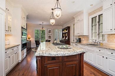 Inspiration for a large transitional u-shaped dark wood floor eat-in kitchen remodel in Miami with an undermount sink, raised-panel cabinets, white cabinets, granite countertops, beige backsplash, glass tile backsplash, stainless steel appliances and an island