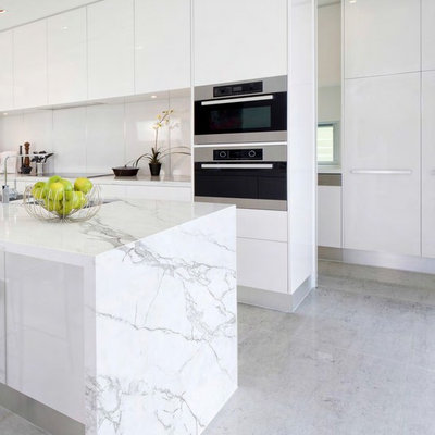Inspiration for a mid-sized modern porcelain tile kitchen remodel in Atlanta with flat-panel cabinets, white cabinets and an island
