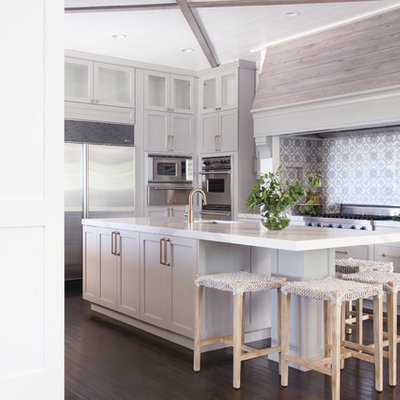 Example of a large transitional u-shaped dark wood floor and brown floor kitchen design in San Diego with an undermount sink, shaker cabinets, gray cabinets, multicolored backsplash, stainless steel appliances, an island and white countertops