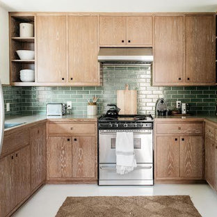 Design ideas for a small tropical u-shaped separate kitchen in Los Angeles with a drop-in sink, flat-panel cabinets, medium wood cabinets, laminate benchtops, green splashback, subway tile splashback, panelled appliances, concrete floors, no island and white floor.