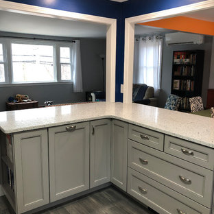 Inspiration for a mid-sized modern l-shaped eat-in kitchen in Boston with an undermount sink, shaker cabinets, grey cabinets, recycled glass benchtops, white splashback, ceramic splashback, stainless steel appliances, porcelain floors, grey floor and white benchtop.