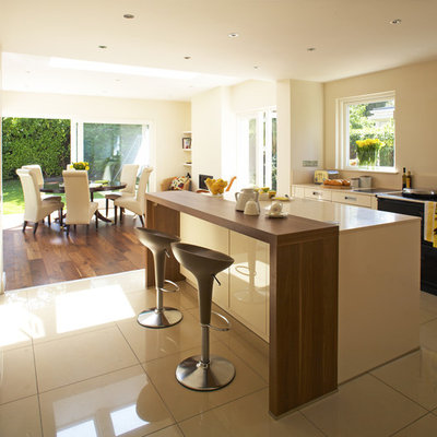 Trendy eat-in kitchen photo in Dublin with wood countertops