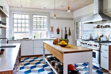 Example of a mid-sized transitional l-shaped painted wood floor and multicolored floor kitchen pantry design in Philadelphia with an undermount sink, flat-panel cabinets, gray cabinets, quartz countertops, multicolored backsplash, ceramic backsplash, stainless steel appliances and an island