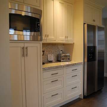 Kitchen pantry cabinet, refridgerator, coffee area and microwave