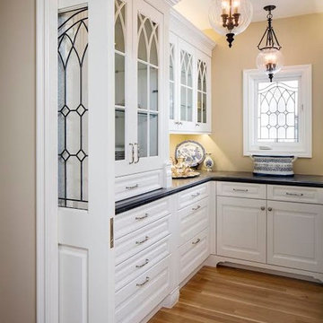 Kitchen Pantry with White Cabinets and Pocket Doors