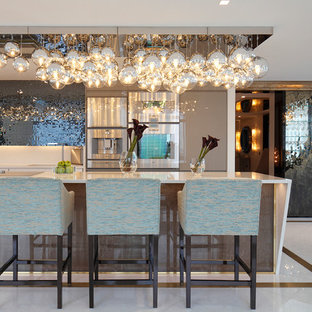 This is an example of a contemporary kitchen in London with flat-panel cabinets and stainless steel appliances.