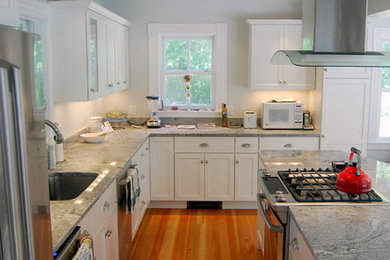 Kitchen - large transitional l-shaped medium tone wood floor kitchen idea in Boston with stainless steel appliances, shaker cabinets, white cabinets, an island and an undermount sink