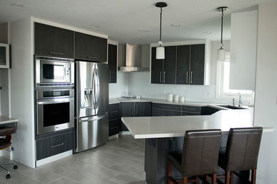 Example of a minimalist kitchen design in Toronto with stainless steel appliances