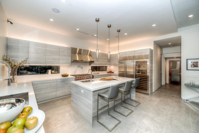 Inspiration for a large modern u-shaped porcelain tile and gray floor eat-in kitchen remodel in Los Angeles with an undermount sink, flat-panel cabinets, gray cabinets, quartz countertops, white backsplash, quartz backsplash, stainless steel appliances, an island and white countertops