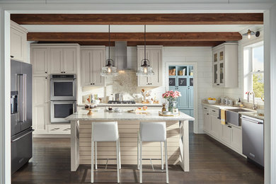 Photo of a large country u-shaped kitchen/diner in Other with a submerged sink, beaded cabinets, beige cabinets, engineered stone countertops, white splashback, porcelain splashback, stainless steel appliances, laminate floors, an island, multi-coloured floors and multicoloured worktops.