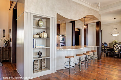 Example of a large trendy u-shaped medium tone wood floor enclosed kitchen design in Charlotte with an undermount sink, raised-panel cabinets, gray cabinets, granite countertops, stainless steel appliances and an island