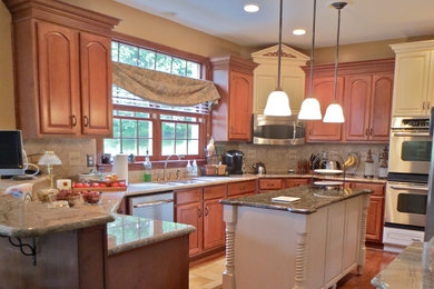 Enclosed kitchen - large traditional u-shaped medium tone wood floor enclosed kitchen idea in Other with a double-bowl sink, raised-panel cabinets, medium tone wood cabinets, granite countertops, beige backsplash, stainless steel appliances and an island