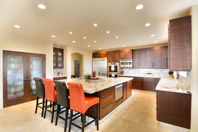 Example of a large trendy l-shaped ceramic tile eat-in kitchen design in Other with a double-bowl sink, flat-panel cabinets, dark wood cabinets, granite countertops, beige backsplash, ceramic backsplash, stainless steel appliances and an island